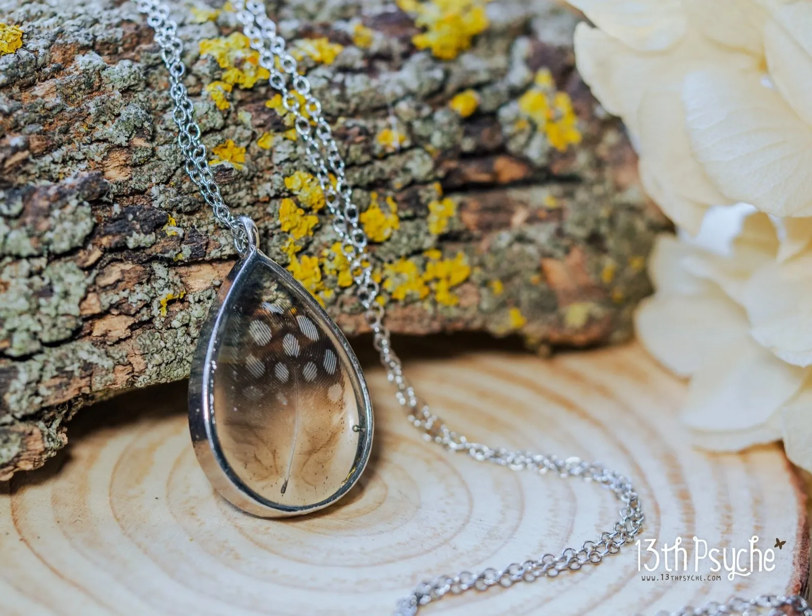 Drop shaped resin pendant with real feather necklace