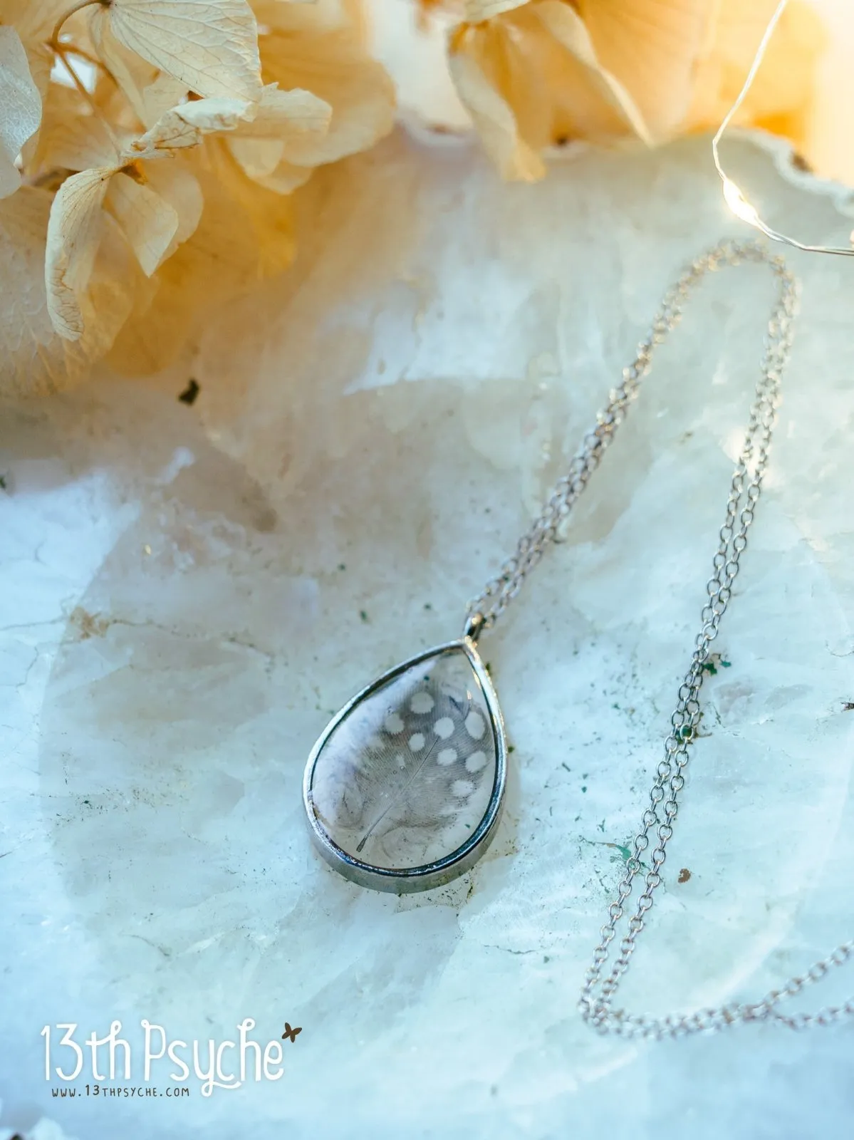 Drop shaped resin pendant with real feather necklace