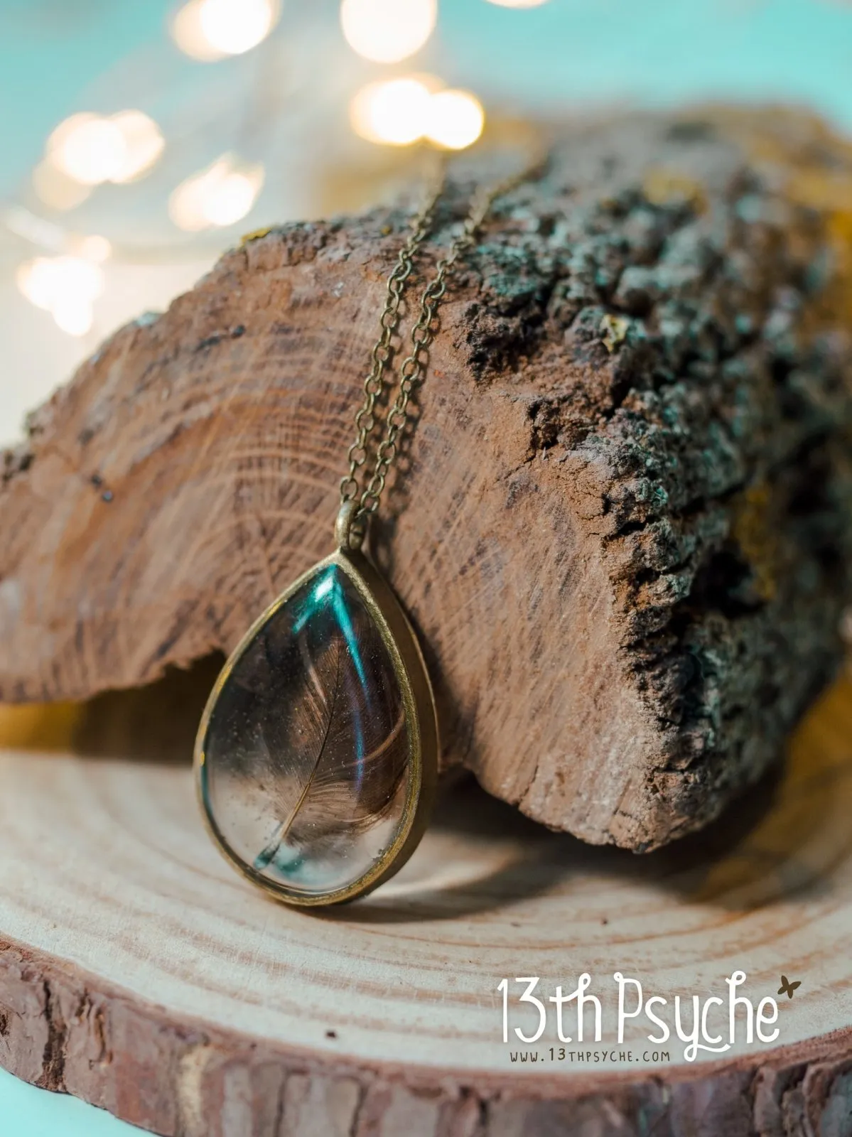 Drop shaped resin pendant with real feather necklace