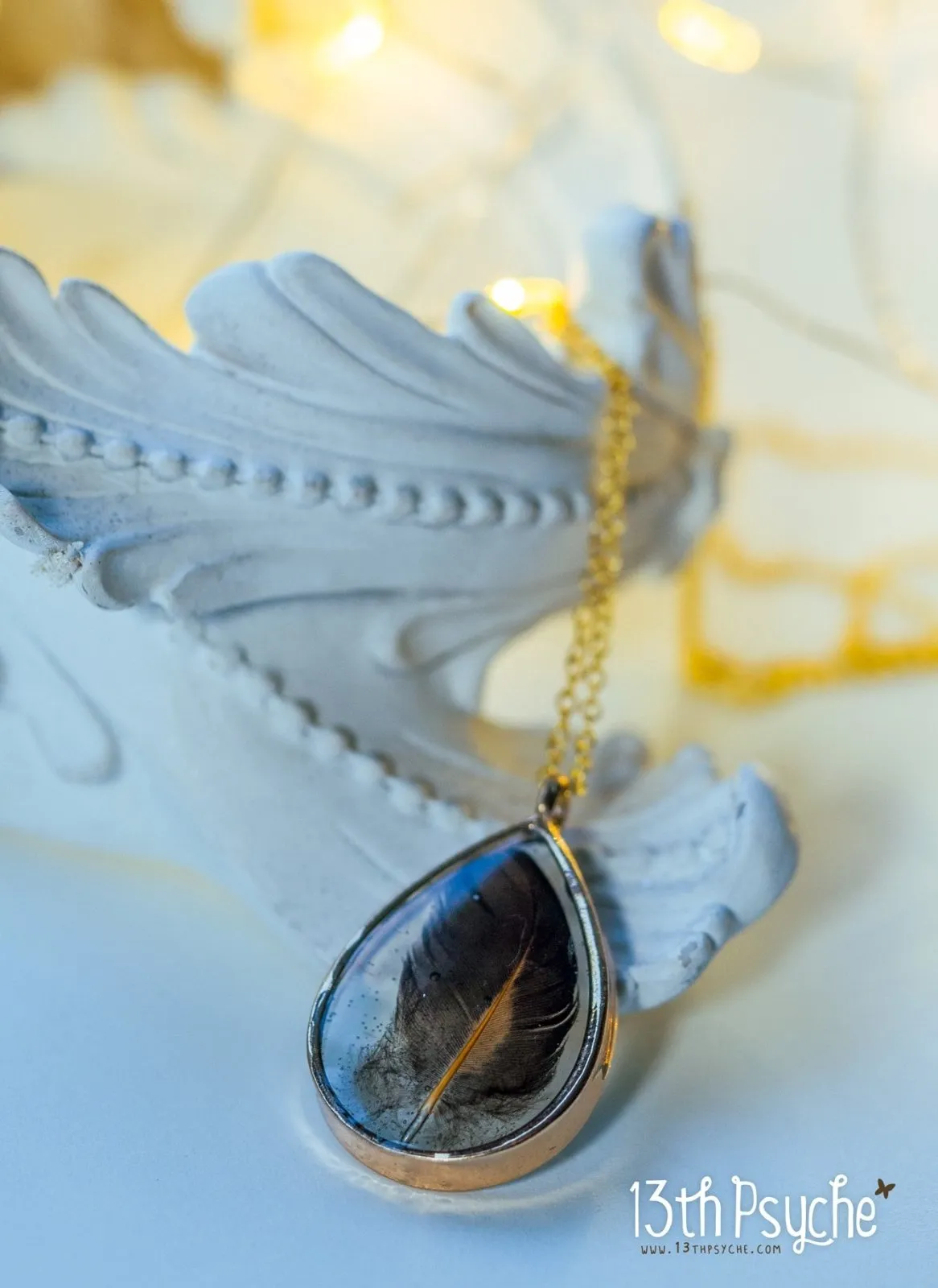 Drop shaped resin pendant with real feather necklace