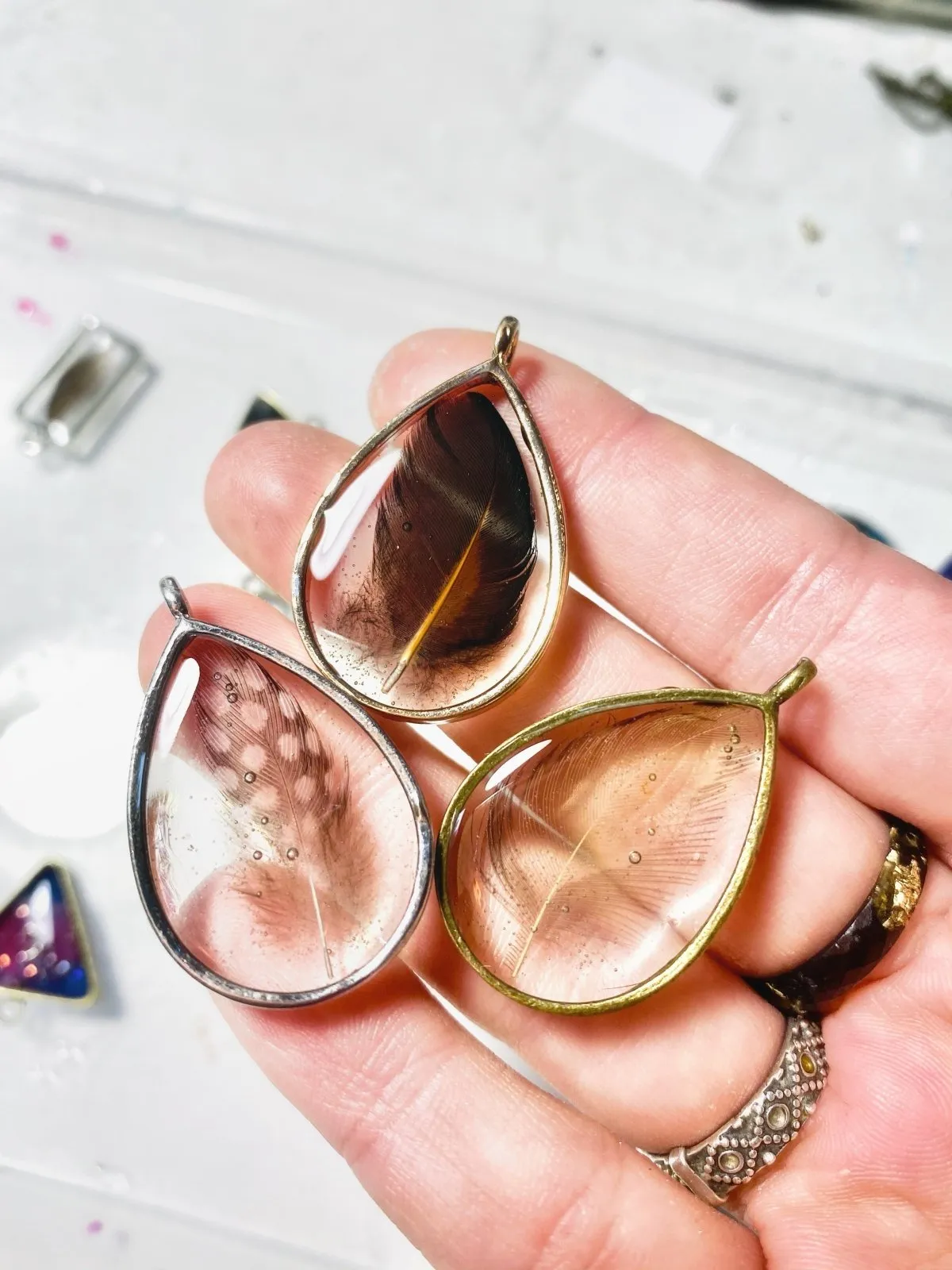 Drop shaped resin pendant with real feather necklace