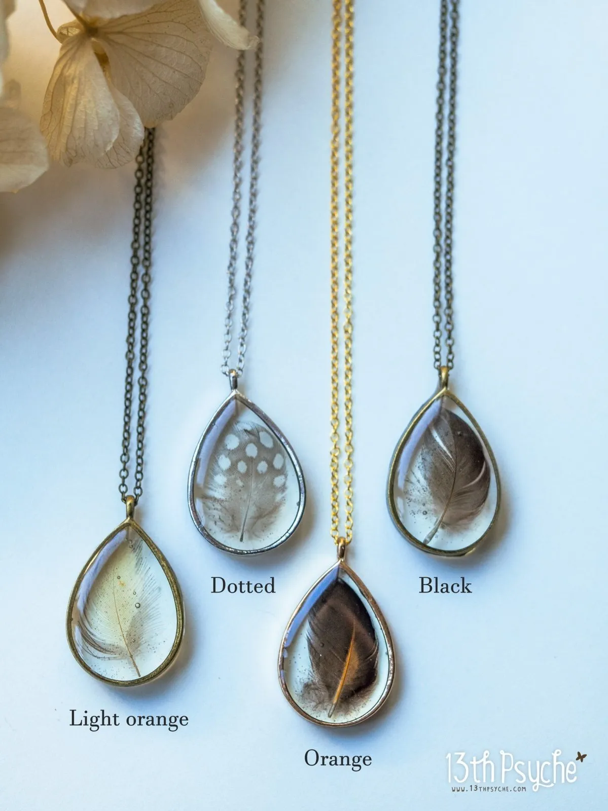 Drop shaped resin pendant with real feather necklace